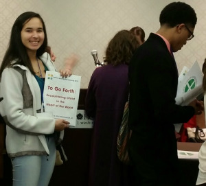 Trinity student with Catholic Social Ministry Gathering registration materials