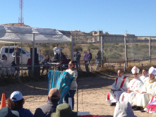 Border fence divides as woman reads Scripture at Mass