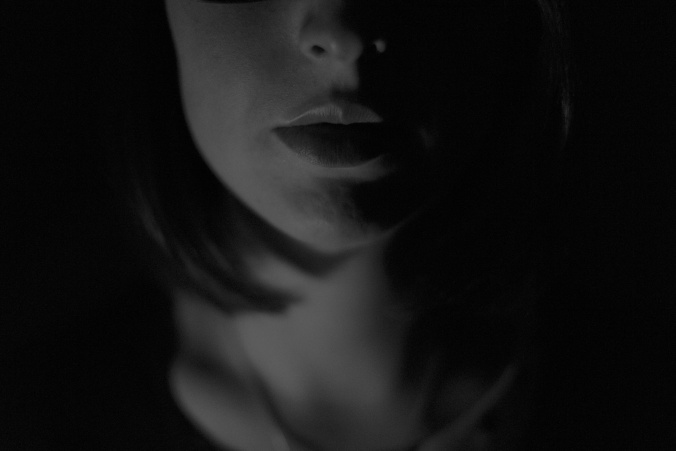 woman's face and neck in shadows