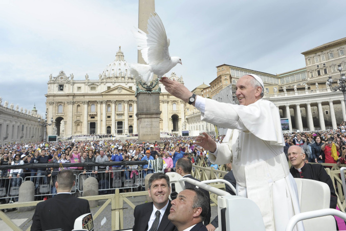 Pope Francis holds dove before his weekly audience at the Vatican