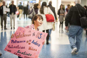 A young girl waits at the airport to greet an arriving refugee familiy. She is participating with her family in the local POWR program at Catholic Charities in Jacksonville, Fla. (Photo by , Sarah Williamson in Jacksonville, Florida)