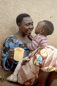 Jeanne Uwimbabazi smiles at her daughter Elissa Izibyose while feeding her porridge during a health and nutrition screening near Buruba Village, Muhanga District, Rwanda. Photo by Laura Elizabeth Pohl for Catholic Relief Services