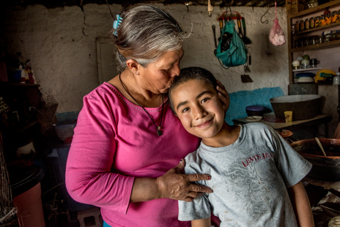 Maria de lu Luz Lego Martinez, here with her grandson Alexis. runs a household without a husband, who went to the US. Of her 10 children, four have died, two live in the United States, and the other four live nearby. Photo by Karen Kasmauski for Catholic Relief Services.